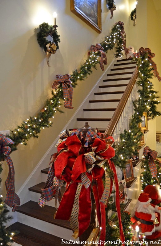 Stairway-Decorated-with-Lit-Garland-and-Ribbon-for-Christmas